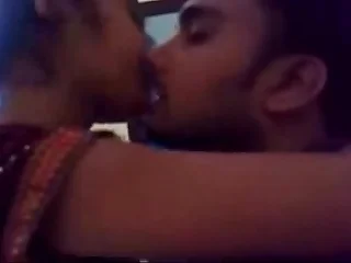 desi girl together with small fry sensual kiss in medley bedroom